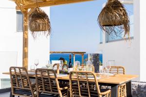 a dining room with a table and chairs at Grand Blue Villas Lachania in Lachania