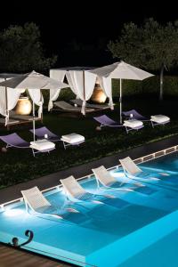 a swimming pool with umbrellas on top of it at Borgo I Vicelli Country Relais in Bagno a Ripoli