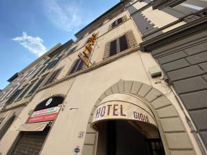 a hotel sign on the side of a building at Hotel Gioia in Florence