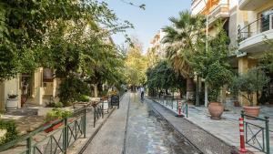 een straat in een stad met bomen en gebouwen bij City Stay close to the National Museum in Athene