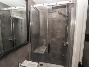 a bathroom with a shower and a sink at The Poppy Fields Abode in Rhyl