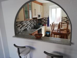 a kitchen with a table and chairs and a mirror at Casa Aral in Fisterra