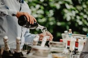 a man pouring a glass of wine on a table at Hotel Nevada in Bormio