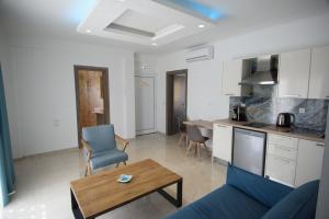 a kitchen and living room with a couch and a table at Golden Sand in Ammoudia