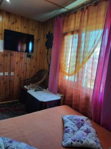 a bedroom with a bed and a sink and a window at Kitech Guest House in Odesa