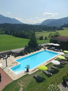 an overhead view of a swimming pool with chairs and umbrellas at Alpin Apart in Flachau