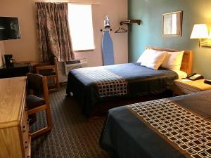 a hotel room with two beds and a window at Travelodge by Wyndham Worland in Worland
