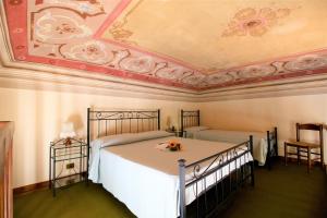 a bedroom with a bed and a ceiling at Villa Teresa in Porto Azzurro