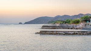 a view of a body of water with mountains in the background at Tylos Beach Hotel in Kato Pyrgos