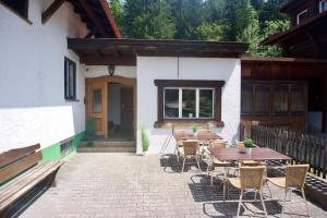 a patio with tables and chairs in front of a building at Mountain Hostel City in Oberstdorf