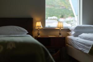 Rúm í herbergi á Hotel Siglunes