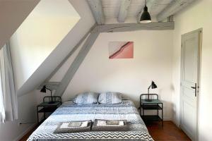 a bedroom with a bed and two night stands at Architecte Les 3 arches de Dormelles in Dormelles