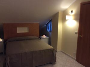 a small bedroom with a bed and a window at Casa Vacanze Samira in Fondachello