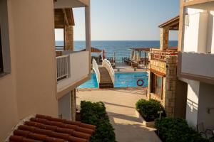 a view of a swimming pool and the ocean from a building at Ekavi Hotel in Sfakaki