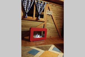 a room with a red tv in front of a stairs at La Casa En El Bosque in El Retiro