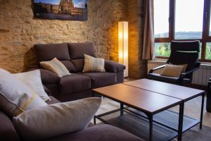 a living room with a couch and a coffee table at Casa Rural Camino Real in Melide