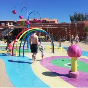 a man and a child playing in a water park at MOBIL HOME camping **** Canet en Roussillon in Canet-en-Roussillon
