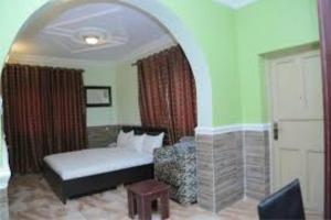 a bedroom with a bed and a couch and a chair at Room in Guest room - Dilida Guest Suites-standard in Jabi