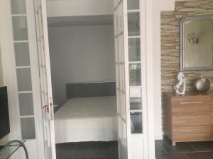 a room with a door open to a bedroom at Loft 1 in La Trinité