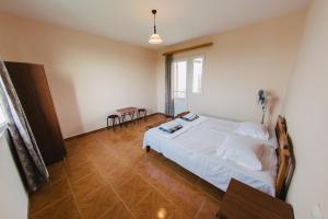 una camera da letto con un grande letto bianco e un tavolo di Nika Inn Kobuleti a Kobuleti