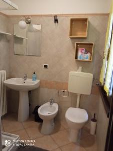 a bathroom with a toilet and a sink at B&B I GEMELLI in Sorbolo