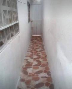a hallway with a floor made out of stones at apartaestudio independiente en Manga, Cartagena in Cartagena de Indias