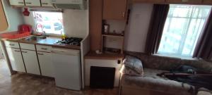 a small kitchen with a couch in a small room at LAWENDOVO in Nowinka