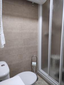 a bathroom with a toilet and a glass shower at Estudio SHEILA in Torrox Costa +2 photos