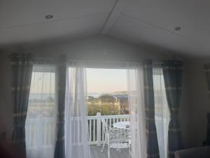 a window with a view of a balcony at Modern Sea View Holiday Home Isle of Wight in Porchfield
