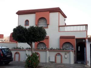 a building with a tree in front of it at L'orientale in Saïdia