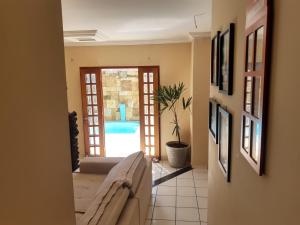 a living room with a couch and an open door at Casa Recanto do sol in Natal +76 photos