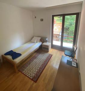Pjer sobe Niska Banja في نيسكا بانجا: غرفة نوم صغيرة بها سرير ونافذة
