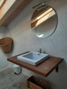 a bathroom with a white sink and a mirror at Granja Masia Katmandu in Cretas