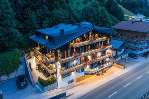 an aerial view of a mansion with a blue roof at Boutique Hotel ANYBODY in Saalbach Hinterglemm