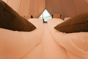 a row of chairs in a tent with pillows at GLAMPNORD in Bodø