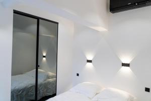 a bedroom with two beds and a mirror at Villa 6 pers à 30m de la mer in Sainte-Maxime +31 photos