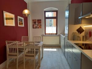 een keuken met een tafel en stoelen in een kamer bij Ferienwohnung Xenia in Pirna