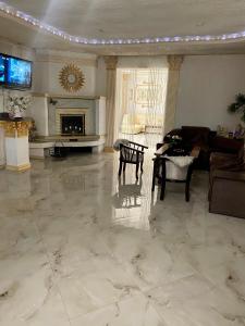 a large living room with a fireplace and a table at Han in Selʼtso
