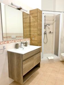 a bathroom with a sink and a shower at LE PALME Loft Apartment in Fossano