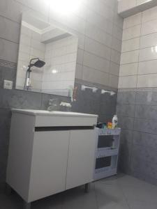 a bathroom with a sink and a mirror at Appartements proches de la mer Boukidan Al Hoceima in Al Hoceïma