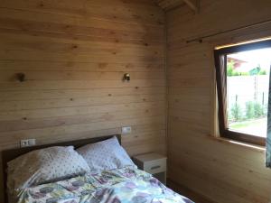 A bed or beds in a room at Przytulisko na Mazurach