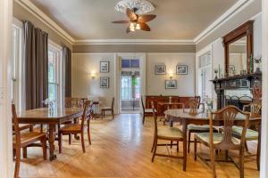 a dining room with tables and chairs and a ceiling fan at Hochelaga Inn in Kingston