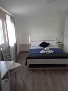sypialnia z łóżkiem z butami w obiekcie Bouganville da Giò w mieście Scalea