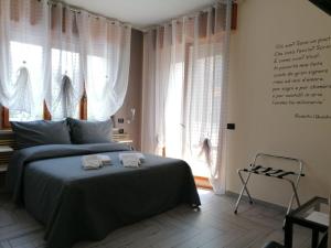 a bedroom with a bed with two towels on it at B&B Armonia in Verona
