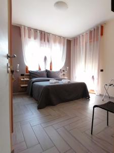 a bedroom with a bed and a large window at B&B Armonia in Verona