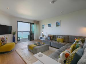 a living room with a couch and a tv at Crystal Bay in St Ives