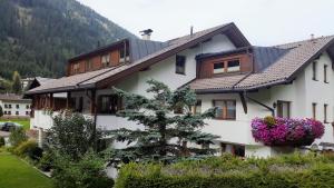 a white house with a tree in front of it at Haus Gfall in Kaunertal