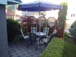 a table and chairs under an umbrella on a patio at Privat Ján Vereš in Rajecké Teplice