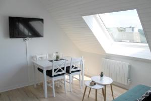 a room with a table and chairs and a window at Cabourg - Studio cosy à 1 min de la plage in Cabourg