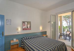 Postel nebo postele na pokoji v ubytování Hotel Apuana